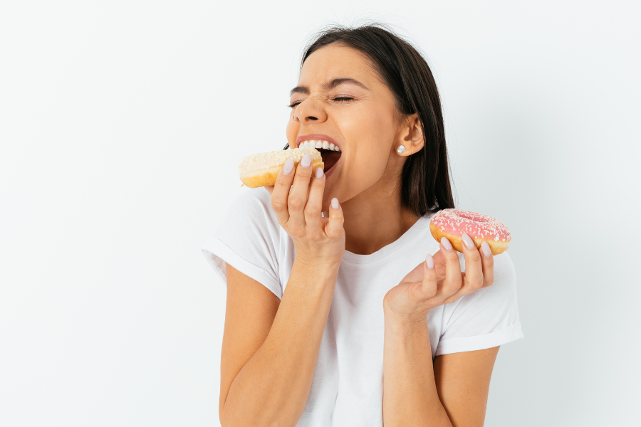 femme en train de manger des beignets. microbiote et perte de poids
